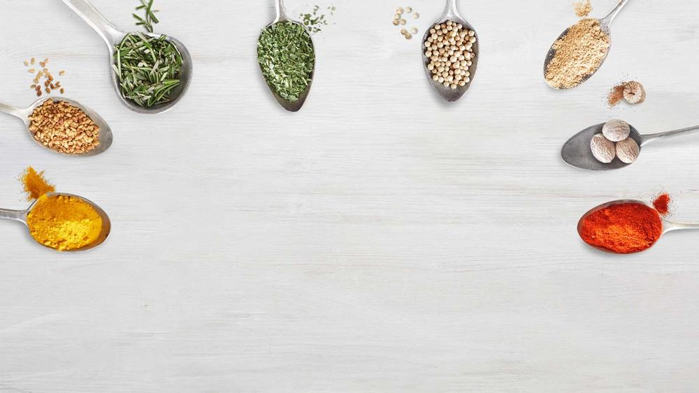 a semi-circle of 8 spoons filled with spices