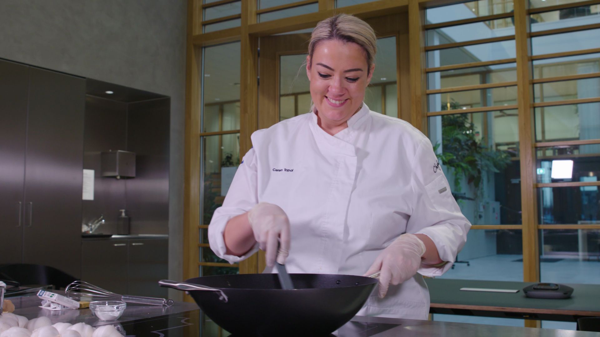 Chef Ceren Topal cooking a General Tso Cauliflower dish.