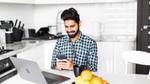 Man with a phone and laptop